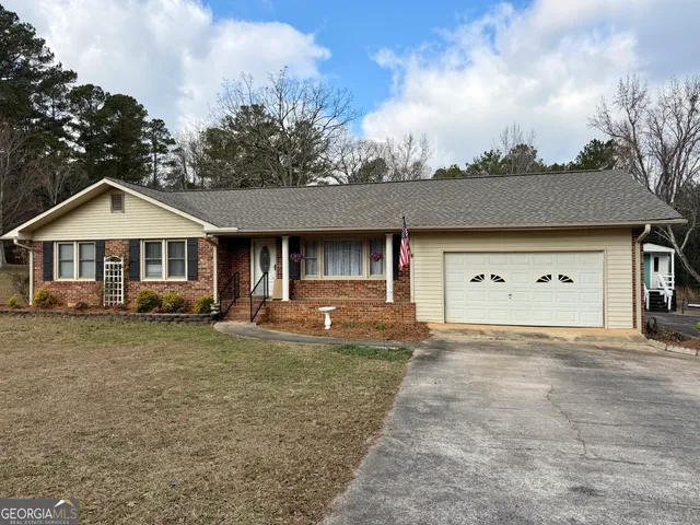a front view of a house with yard and porch
