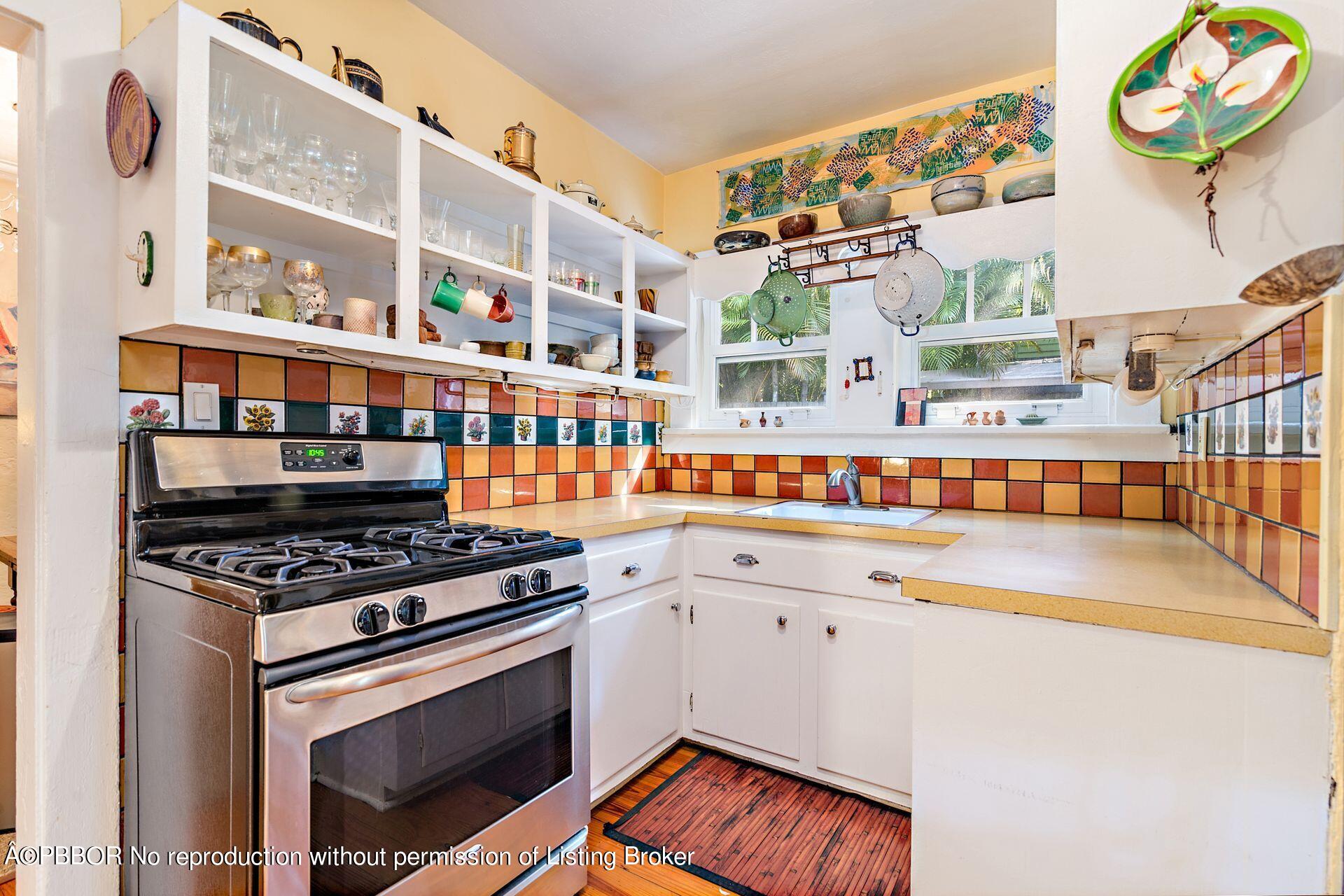 810 Avon Road West Palm Beach, FL 33401 - Photo 9 of 23 a kitchen with stainless steel appliances granite countertop a stove and a sink