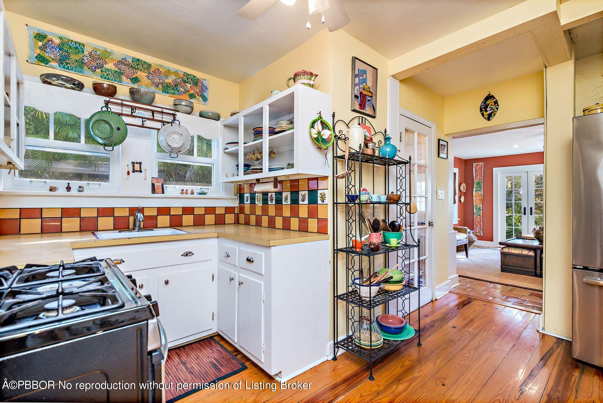 810 Avon Road West Palm Beach, FL 33401 - Photo 10 of 23 a kitchen with lots of clutter and wooden cabinets