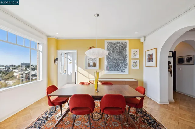 a living room with furniture a rug and a bookshelf