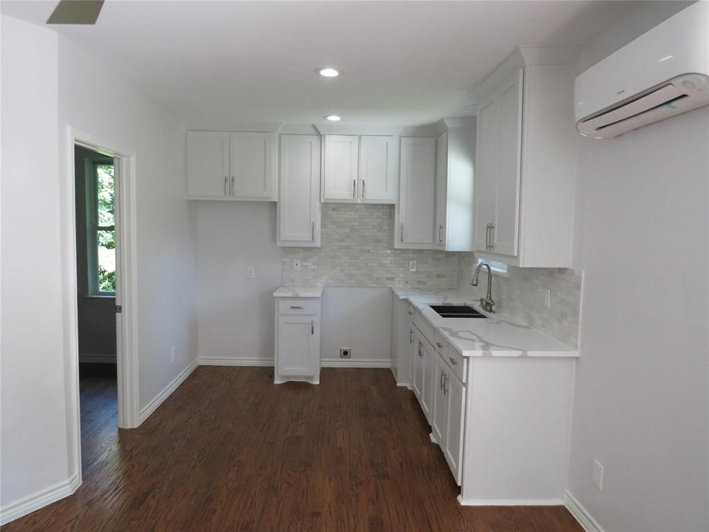 818 Thomas Street Denton, TX 76201 - Photo 2 of 7 a kitchen with a sink stove and cabinets