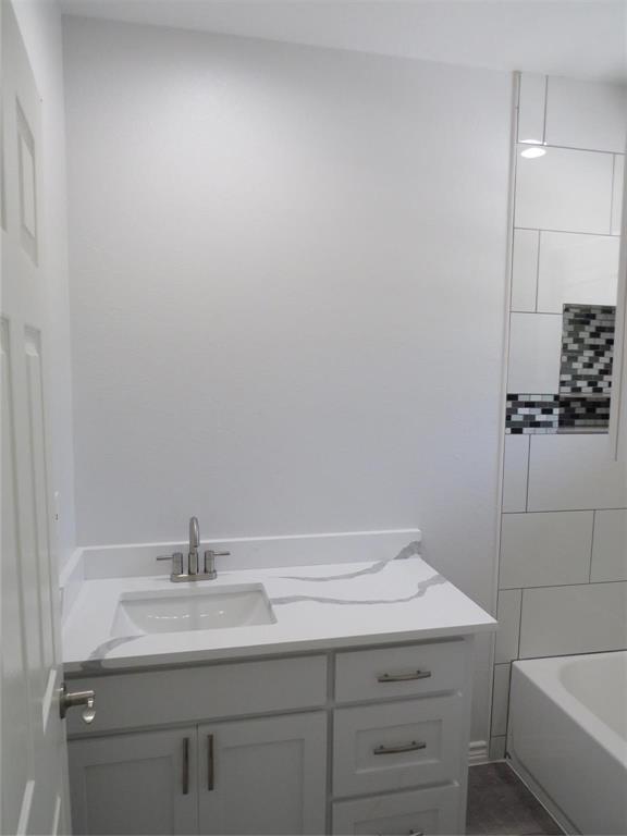 818 Thomas Street Denton, TX 76201 - Photo 6 of 7 a bathroom with a sink and a mirror