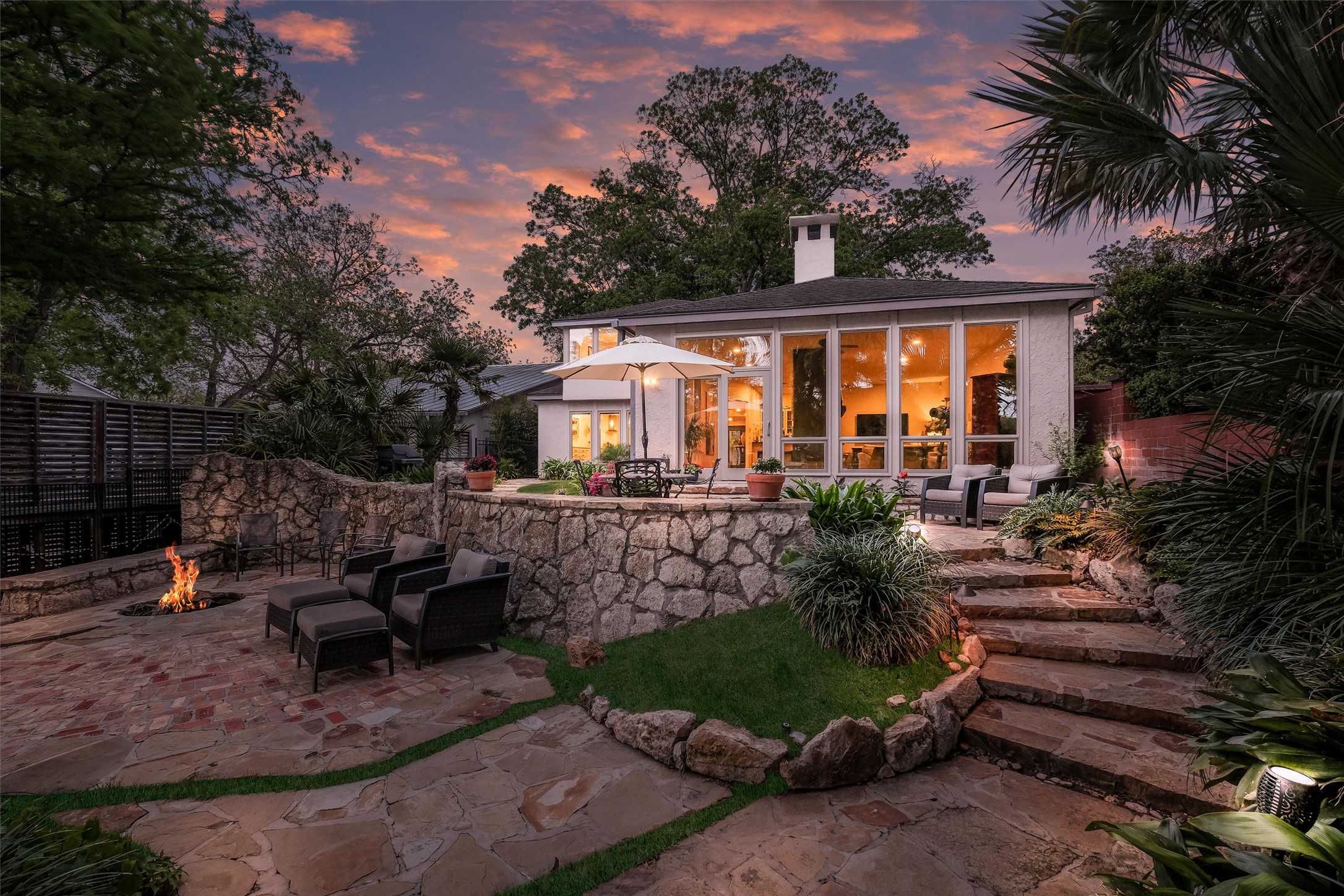 1807 Terminal Loop Road McQueeney, TX 78123 - Photo 23 of 32 Back of house at dusk featuring a patio area, a chimney, and an outdoor living space with a fire pit