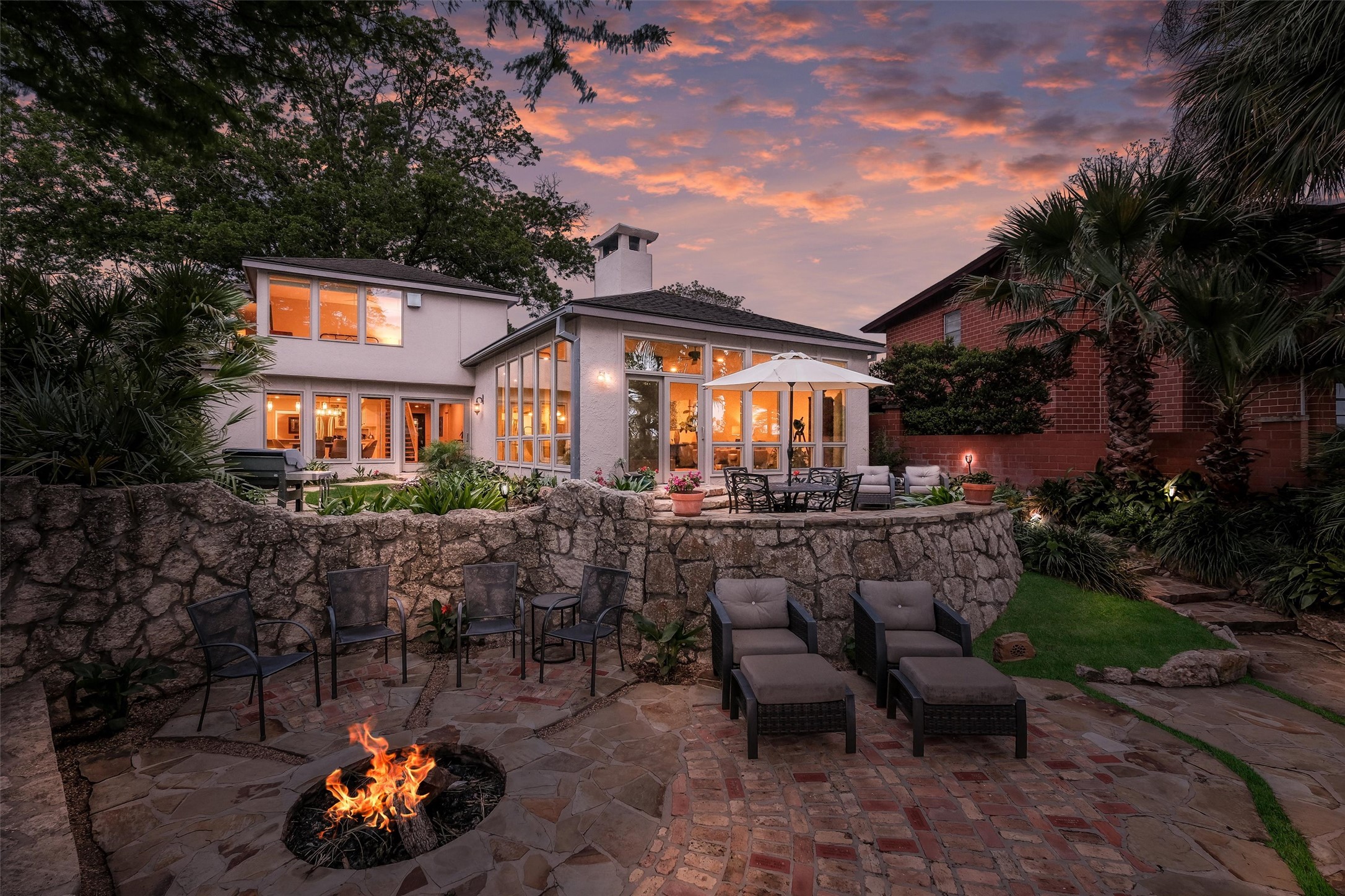 1807 Terminal Loop Road McQueeney, TX 78123 - Photo 6 of 32 Back of house at dusk featuring outdoor dining area, a fire pit, a multiple seating areas.