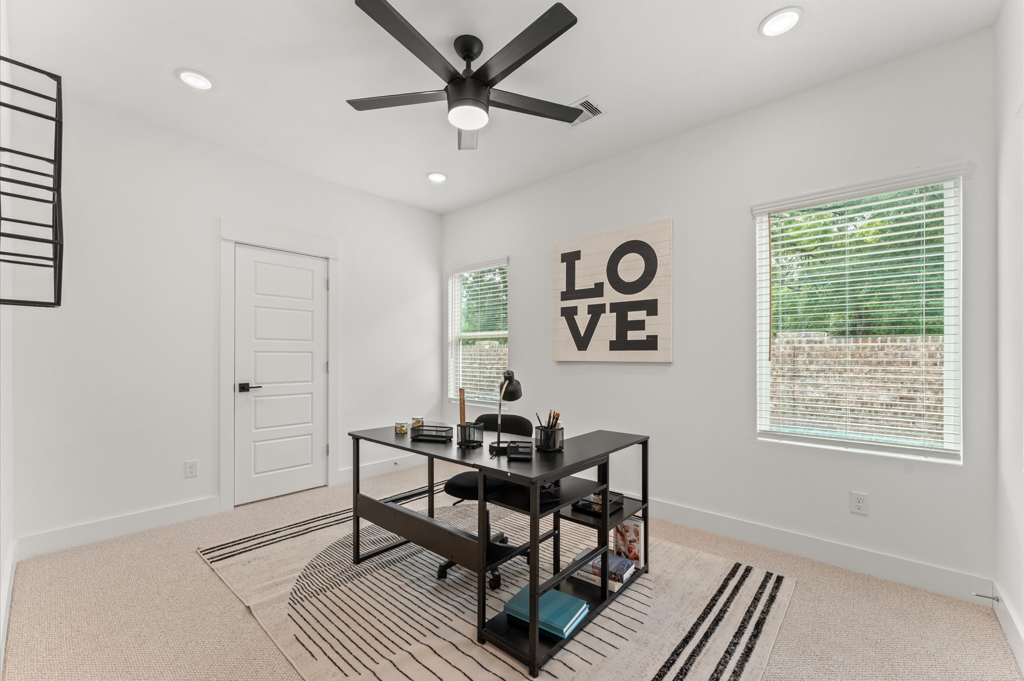 2710 Jensen Drive Houston, TX 77026 - Photo 20 of 38 Versatile secondary bedroom on the first floor, thoughtfully staged as a home office yet adaptable to suit any lifestyle need. The space boasts warm natural light and easy access to a shared Jack and Jill bathroom, adding both function and privacy.