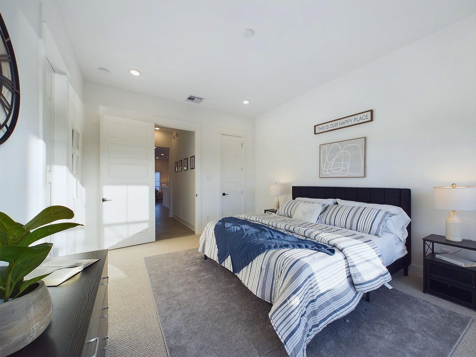 2710 Jensen Drive Houston, TX 77026 - Photo 22 of 38 This spacious second-floor primary bedroom exudes modern elegance with its sleek engineered wood flooring that adds warmth and texture underfoot. High ceilings and big windows amplify the sense of openness, allowing natural light to cascade in and highlight the room’s charm. Whether styled with minimalist furnishings or layered with cozy accents, the space offers a serene retreat.