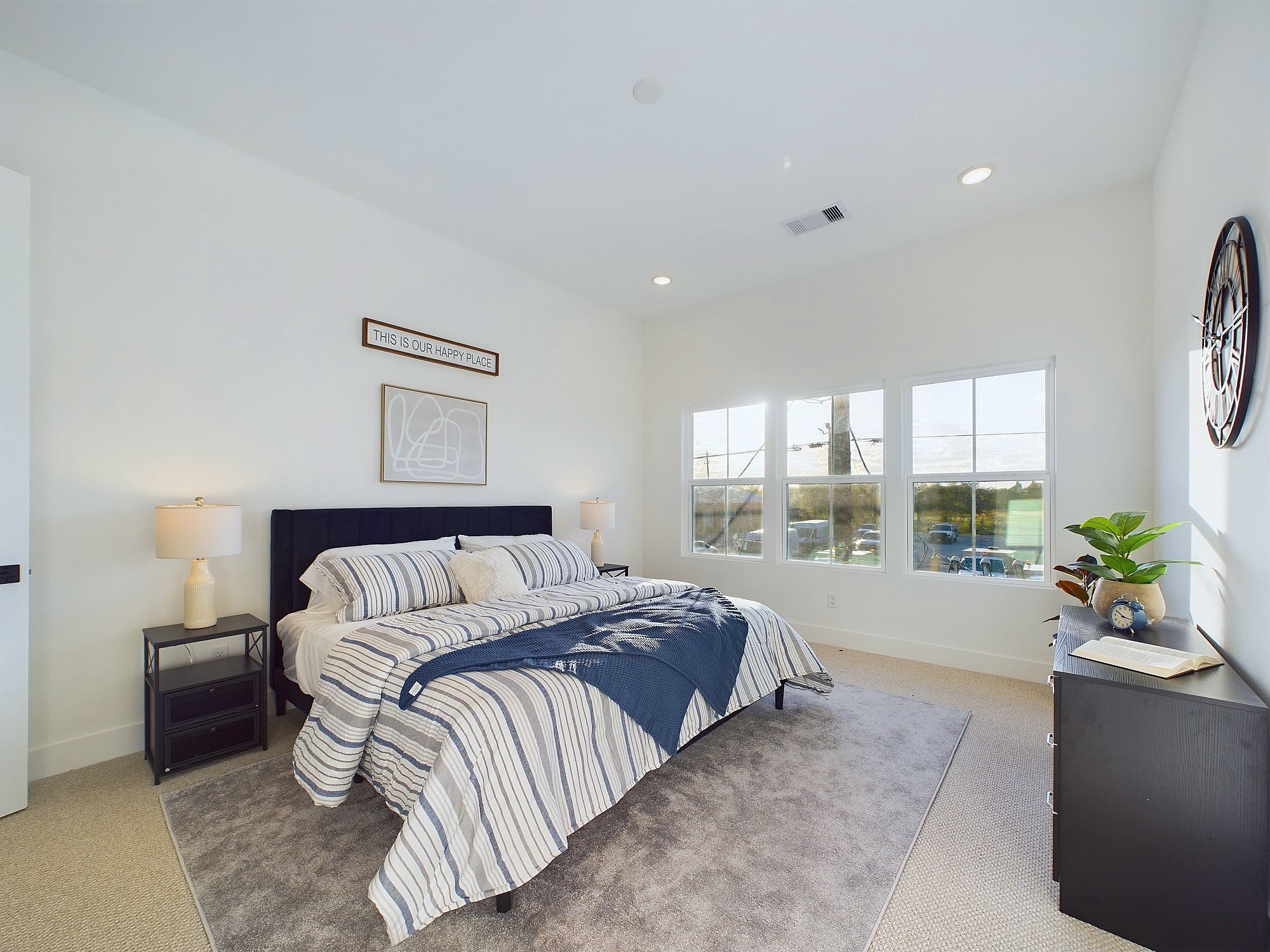 2710 Jensen Drive Houston, TX 77026 - Photo 23 of 38 This spacious second-floor primary bedroom exudes modern elegance with its sleek engineered wood flooring that adds warmth and texture underfoot. High ceilings and big windows amplify the sense of openness, allowing natural light to cascade in and highlight the room’s charm. Whether styled with minimalist furnishings or layered with cozy accents, the space offers a serene retreat.