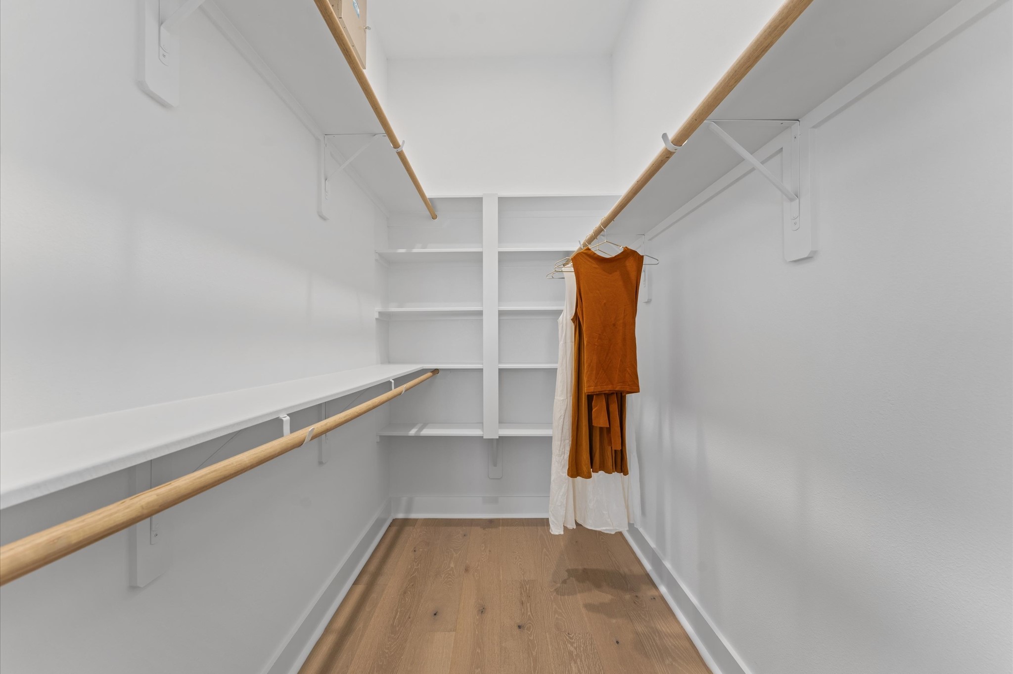 2710 Jensen Drive Houston, TX 77026 - Photo 27 of 38 This well-proportioned primary closet offers a practical blend of space and organization, ideal for everyday use. With ample room for hanging garments and shelving for folded items or accessories, it balances functionality with comfort. The layout allows for easy access and visibility, making it simple to keep clothing and essentials neatly arranged. Whether customized with built-ins or left open for flexible storage, the closet serves as a tidy extension of the primary suite.