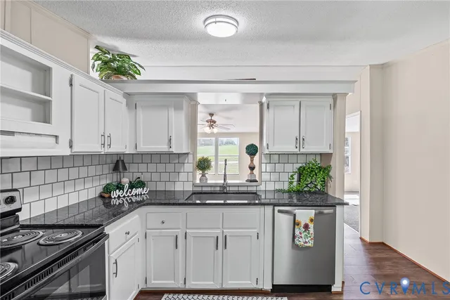 a kitchen with stainless steel appliances granite countertop a sink and a stove