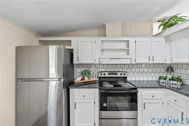 a kitchen with a refrigerator and a stove top oven