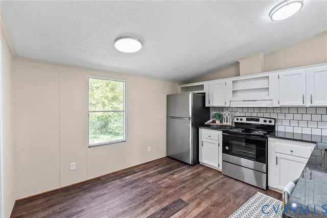 a kitchen with a stove a sink and a refrigerator
