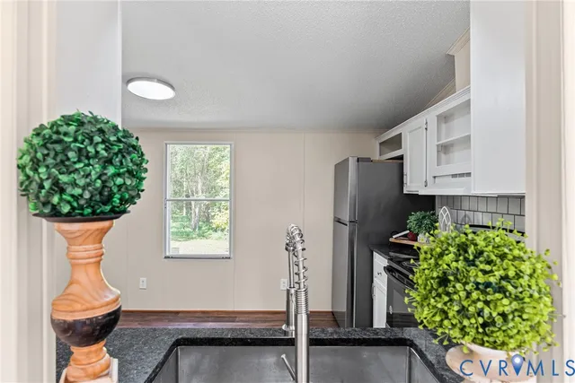 a room with a fireplace and potted plants