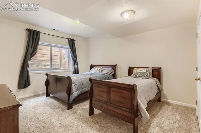 a spacious bedroom with two beds and a large window