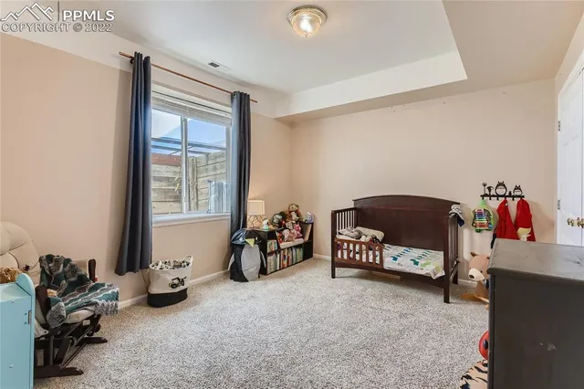 a bedroom with furniture and a large window