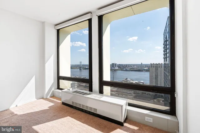 a living room with couch next to a window