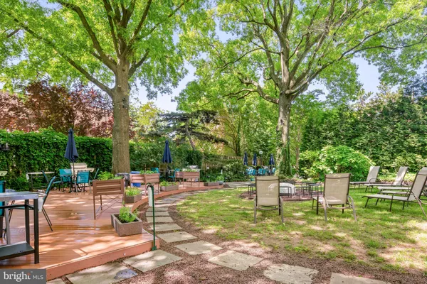 a table and chairs in front of a yard