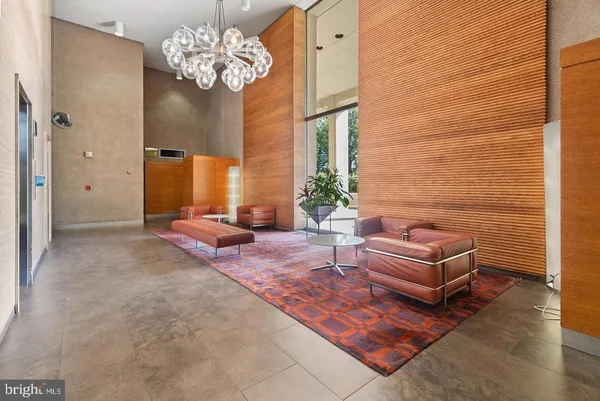 a living room with patio chandelier furniture and a chandelier