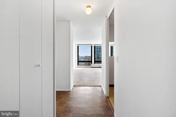 a view of a hallway with wooden shelves