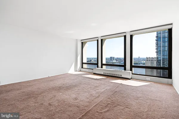 an empty room with wooden floor and sliding door