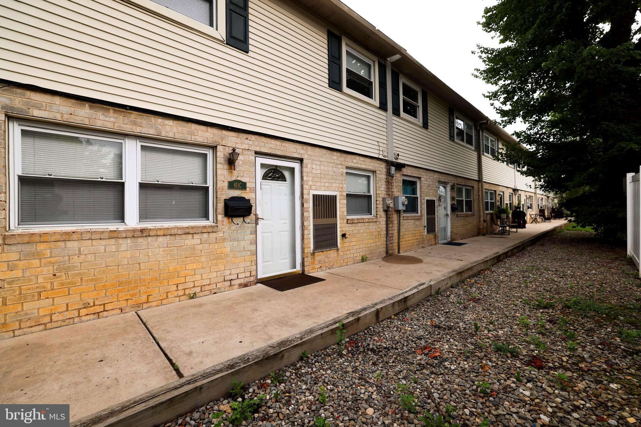 a view of a blue house with large windows
