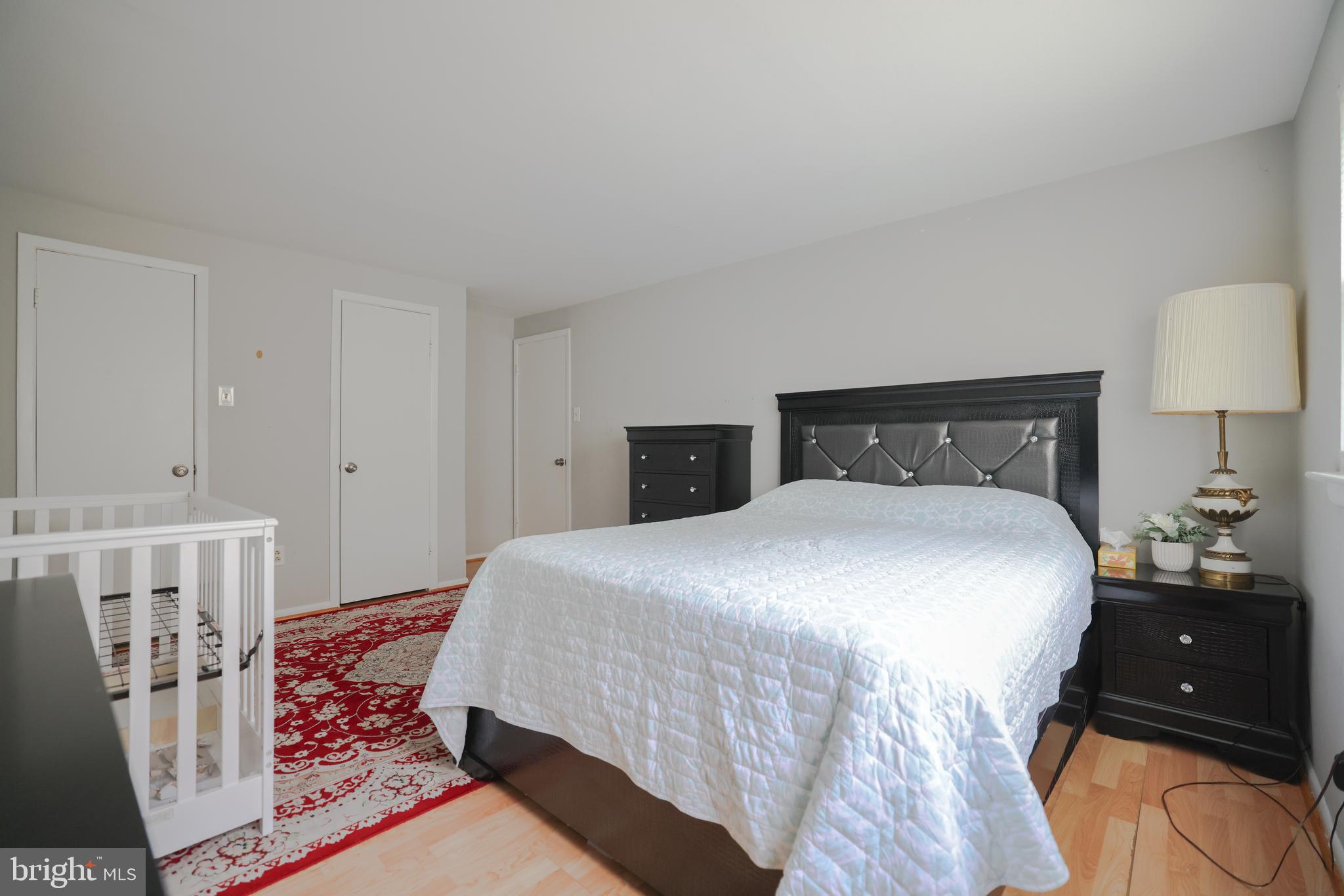 611 Edison Avenue, Unit C Philadelphia, PA 19116 - Photo 12 of 30 a bedroom with a bed and a lamp
