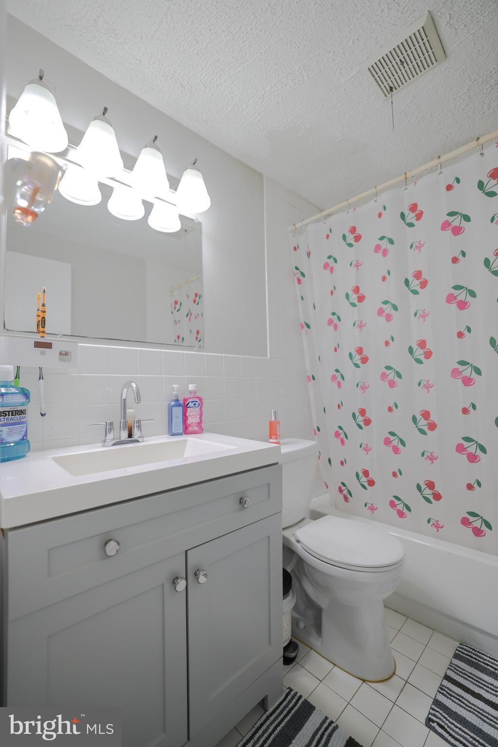 611 Edison Avenue, Unit C Philadelphia, PA 19116 - Photo 15 of 30 a bathroom with a sink a toilet and a mirror