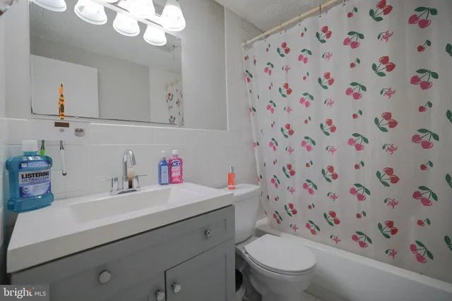 a bathroom with a sink toilet and a mirror