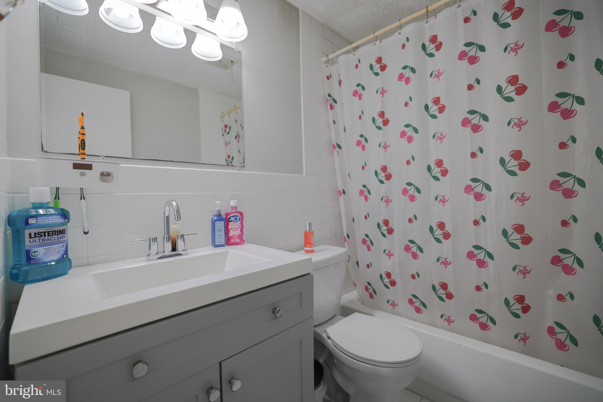 611 Edison Avenue, Unit C Philadelphia, PA 19116 - Photo 16 of 30 a bathroom with a sink toilet and a mirror