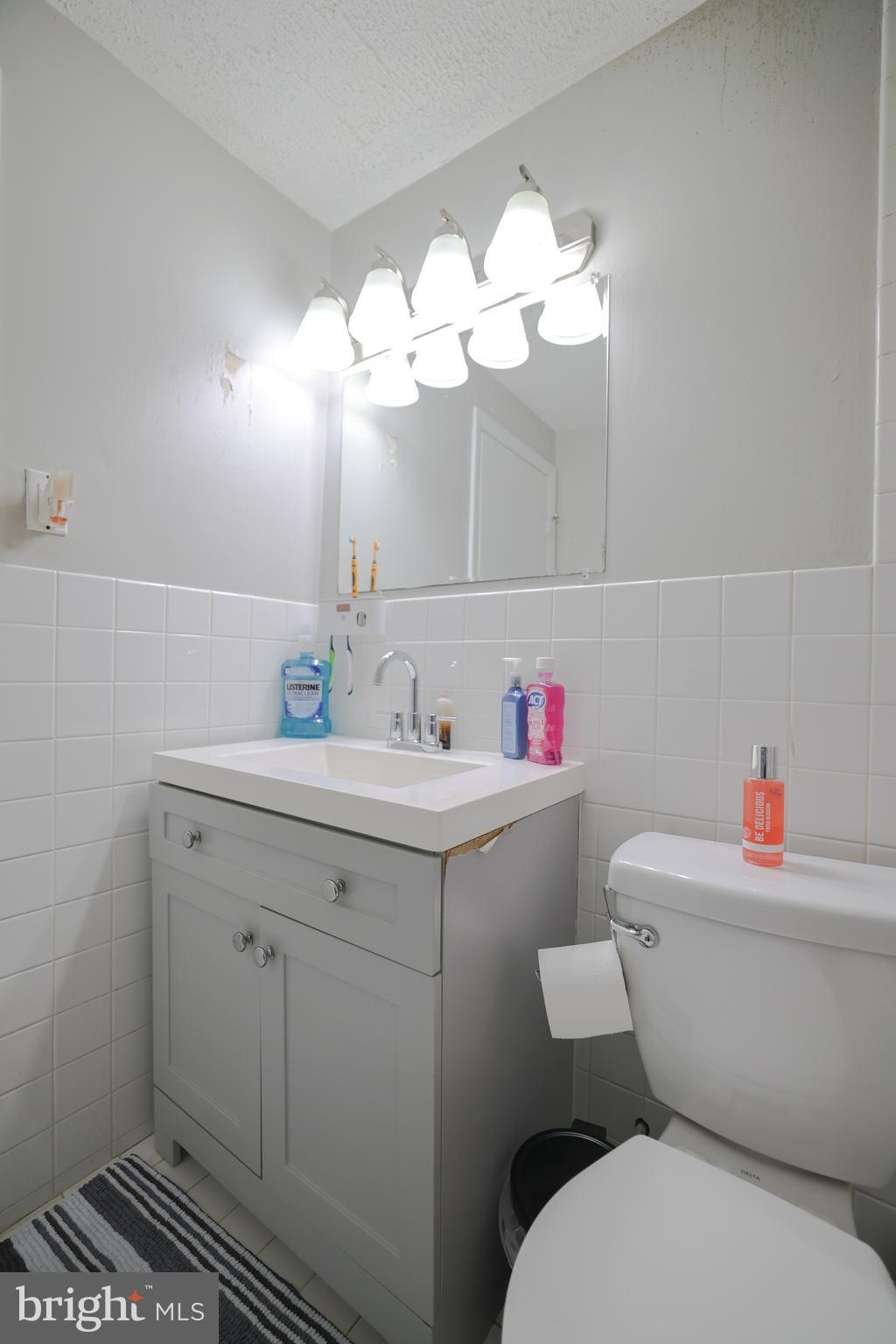 611 Edison Avenue, Unit C Philadelphia, PA 19116 - Photo 17 of 30 a bathroom with a sink mirror and toilet
