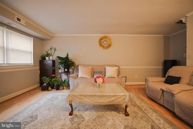 a living room with furniture and flowers