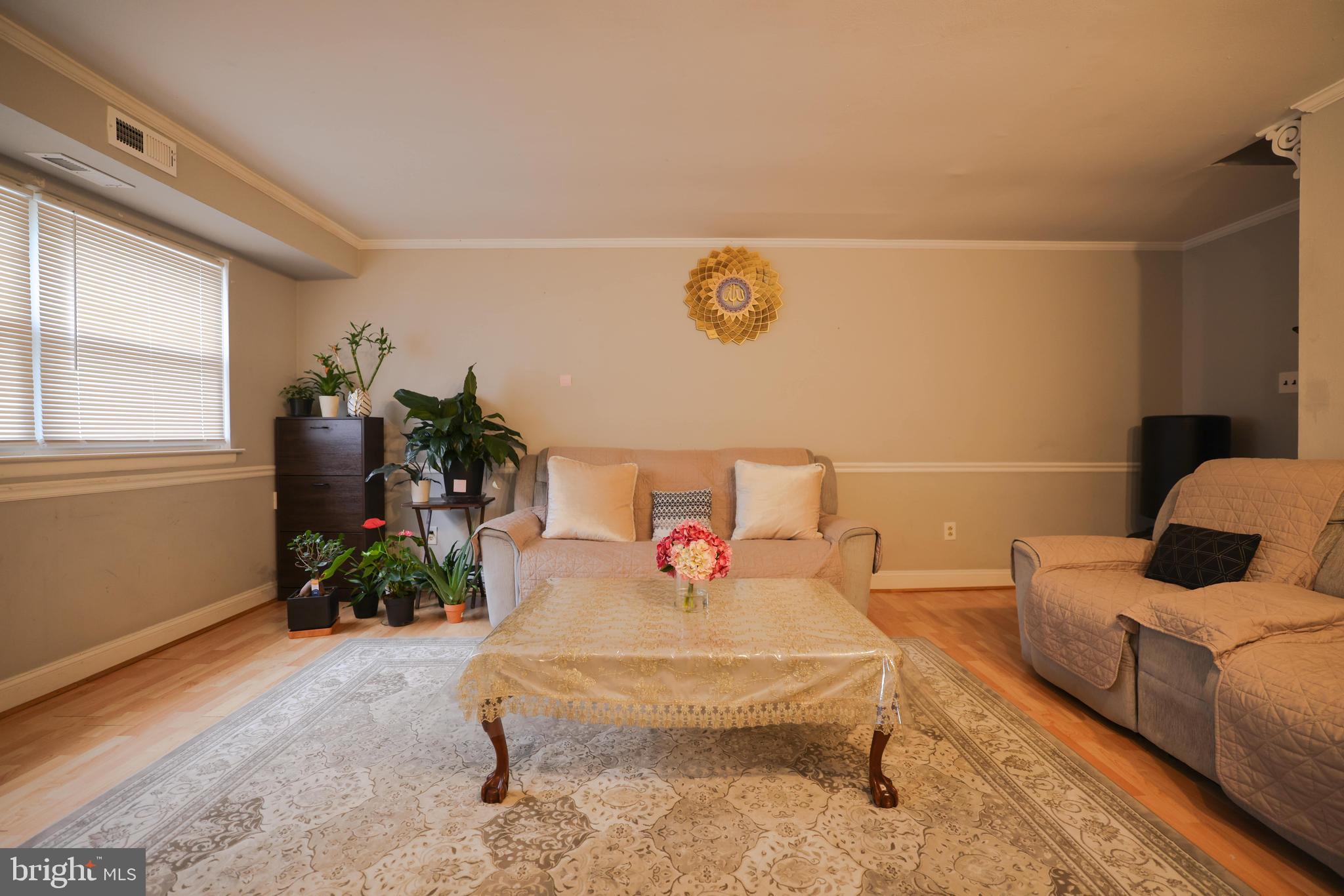 611 Edison Avenue, Unit C Philadelphia, PA 19116 - Photo 23 of 30 a living room with furniture and flowers