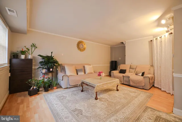a living room with furniture and flowers