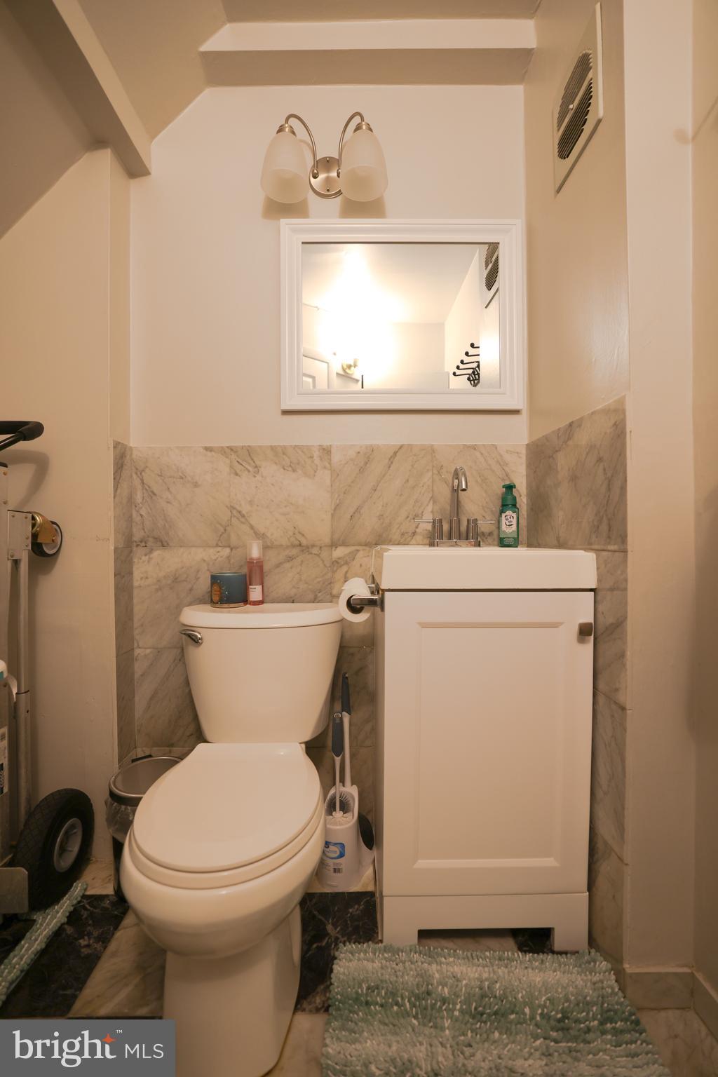 611 Edison Avenue, Unit C Philadelphia, PA 19116 - Photo 9 of 30 a bathroom with a toilet sink and mirror