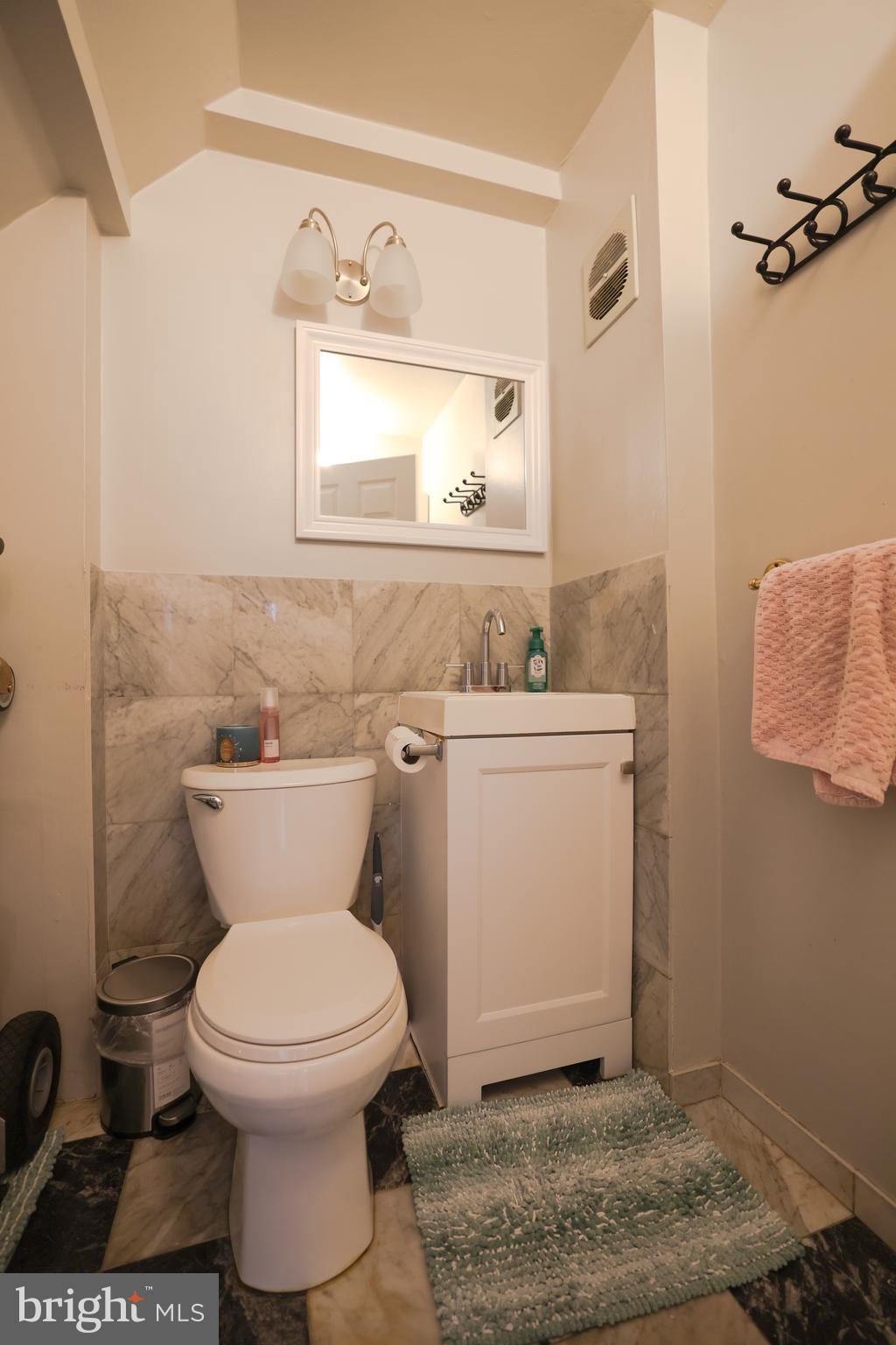 611 Edison Avenue, Unit C Philadelphia, PA 19116 - Photo 10 of 30 a bathroom with a toilet sink and mirror