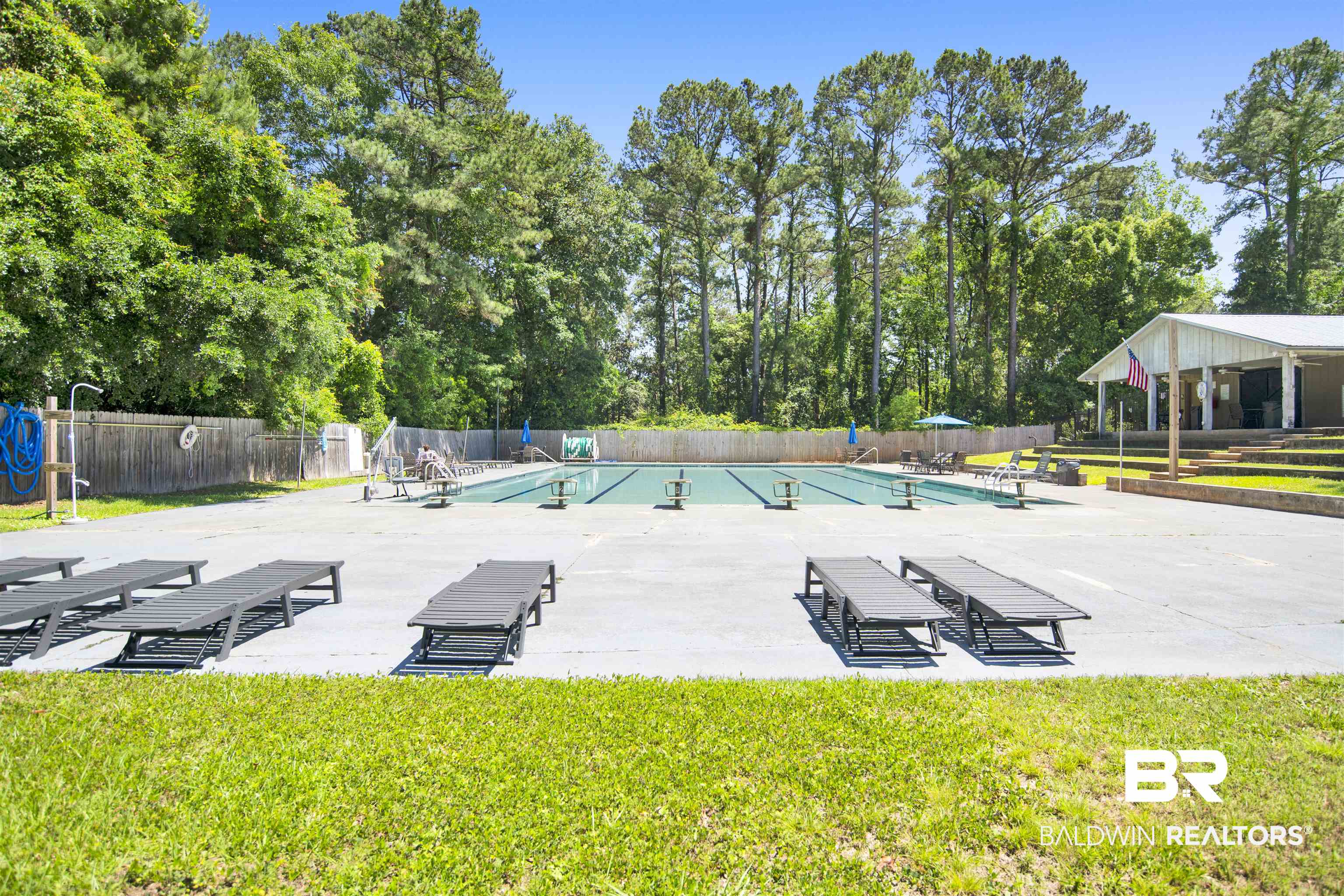 107 Virginia Circle Daphne, AL 36526 - Photo 40 of 47 Community swimming pool with a covered pavilion, surrounded by mature trees and a privacy fence