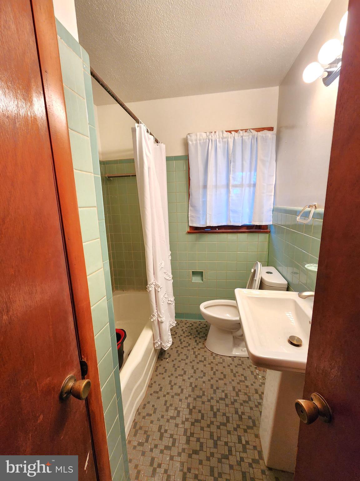 8754 Concord Road Seaford, DE 19973 - Photo 11 of 21 a bathroom with a sink toilet and shower