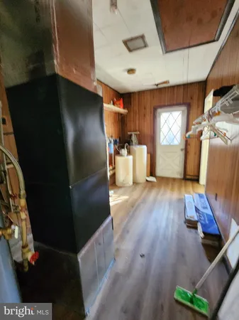 a kitchen with a refrigerator and wooden floor