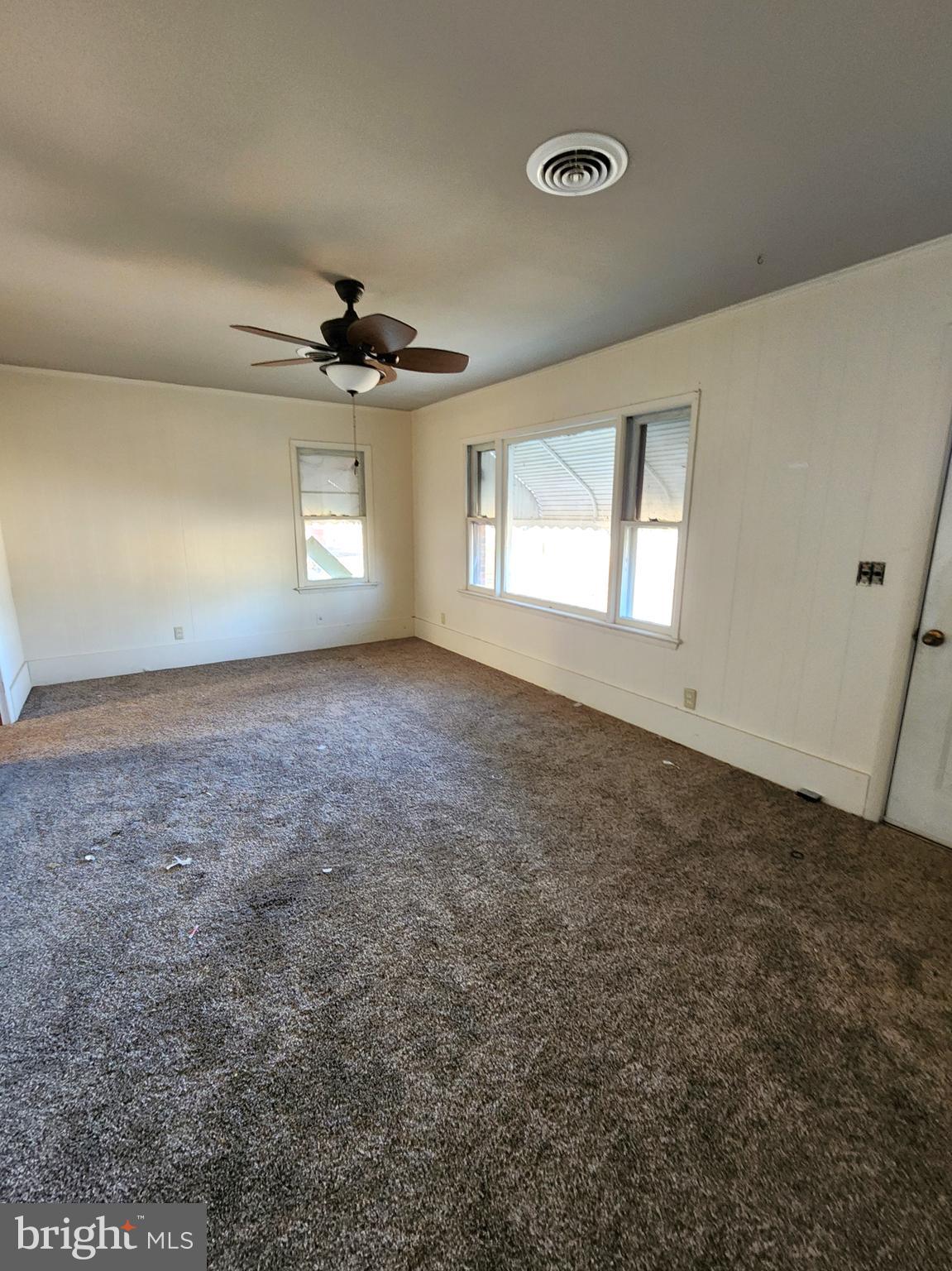 8754 Concord Road Seaford, DE 19973 - Photo 2 of 21 an empty room with windows and ceiling fan