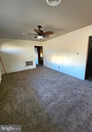 a view of an empty room and a fireplace
