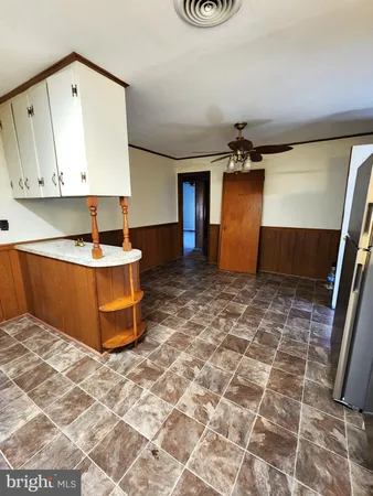 a room with pool table and a potted plant
