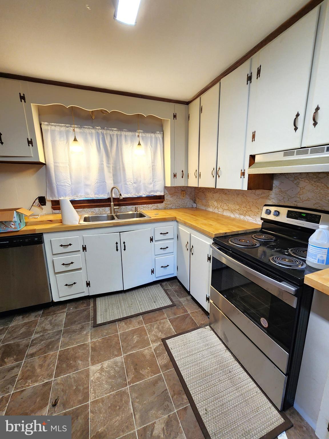 8754 Concord Road Seaford, DE 19973 - Photo 7 of 21 a kitchen with stainless steel appliances a sink window and cabinets