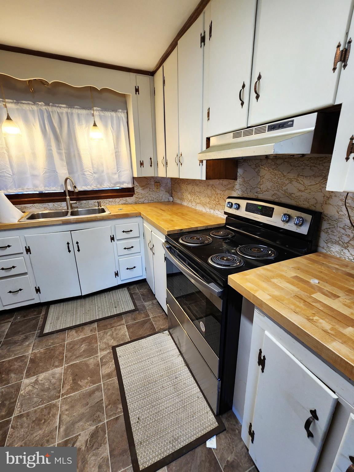 8754 Concord Road Seaford, DE 19973 - Photo 8 of 21 a kitchen with granite countertop white cabinets and white appliances