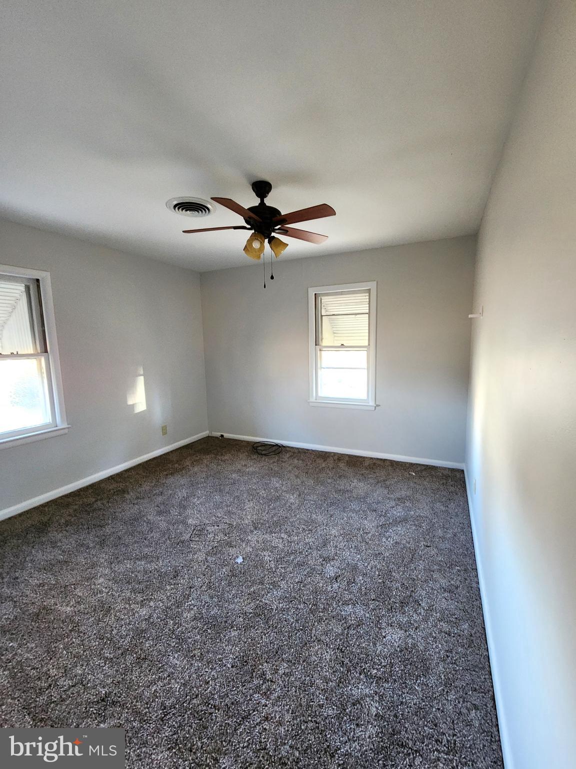 8754 Concord Road Seaford, DE 19973 - Photo 9 of 21 an empty room with windows and fan