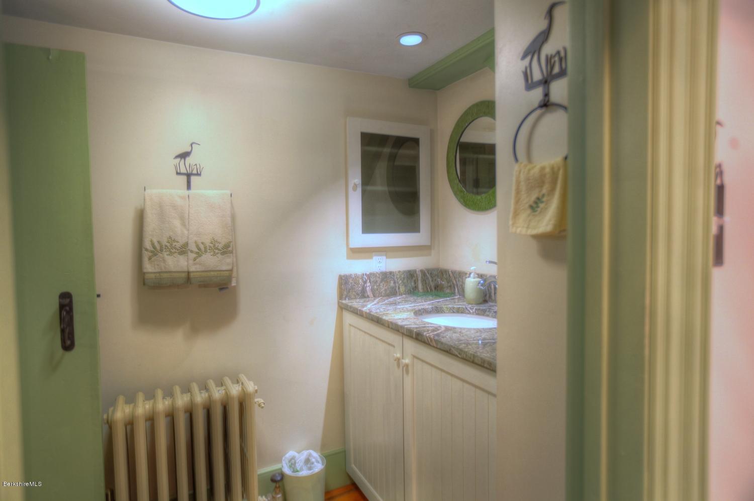 1226 State Road Richmond, MA 01254 - Photo 36 of 50 a bathroom with a granite countertop sink and mirror
