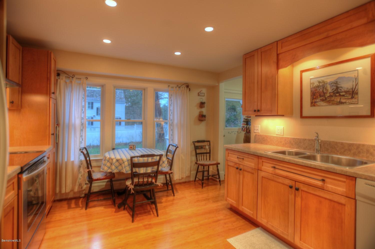 1226 State Road Richmond, MA 01254 - Photo 40 of 50 a kitchen with stainless steel appliances granite countertop a table chairs and a refrigerator