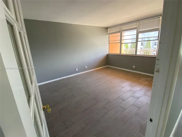 a view of a hallway with wooden shelves
