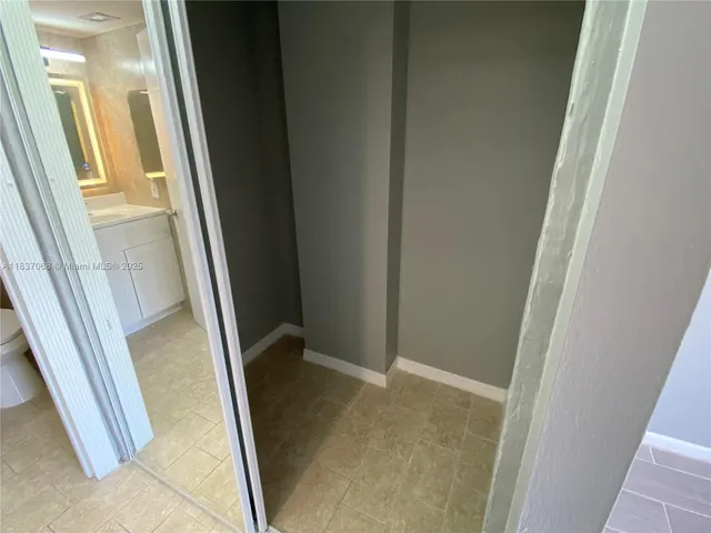 a bathroom with a shower and a toilet sink