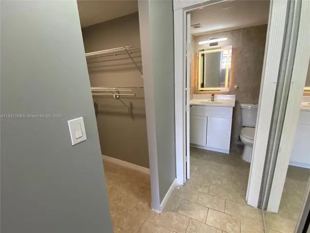 a bathroom with a sink a toilet a mirror and vanity