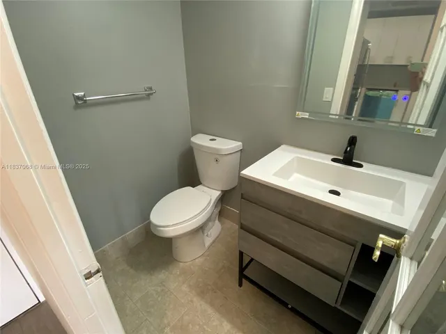 a kitchen with a refrigerator and a sink