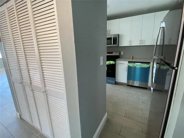 a kitchen with stainless steel appliances a refrigerator a sink a stove top oven